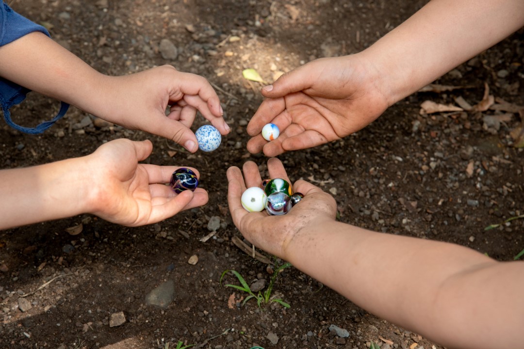 4 Hands 3 Hands With 1 Marble 1 Hand With 4 Marbles Shutterstock 2287539295