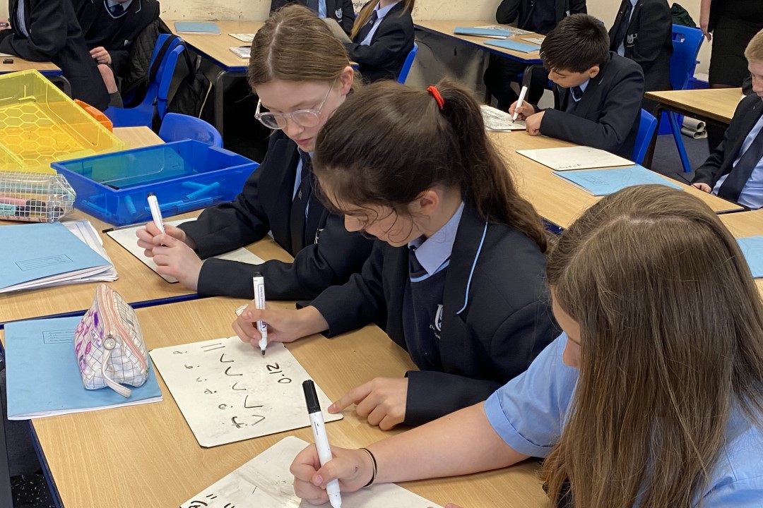 Three Students At A Desk Image 8